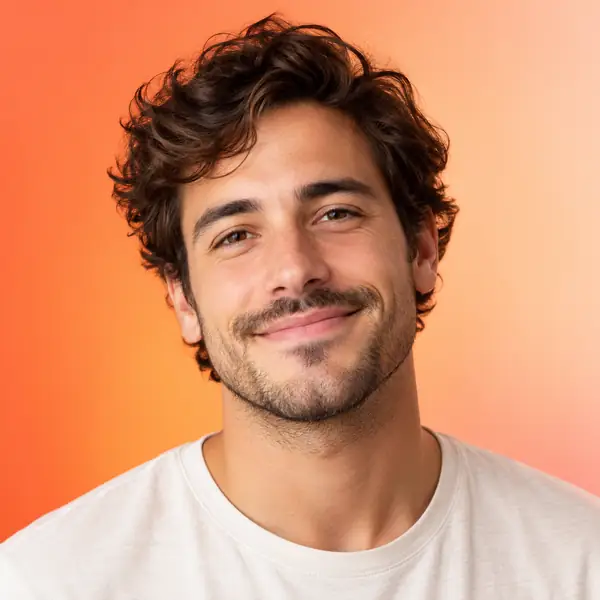 Friendly man's portrait against a soft orange-to-peach gradient background