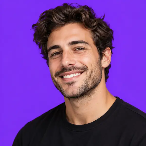 Smiling man's profile portrait against a bold solid violet background